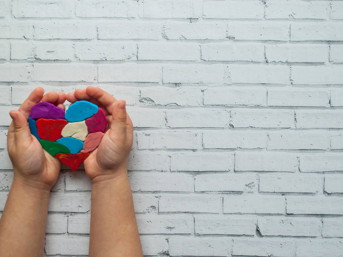 someone holding a molded clay heart