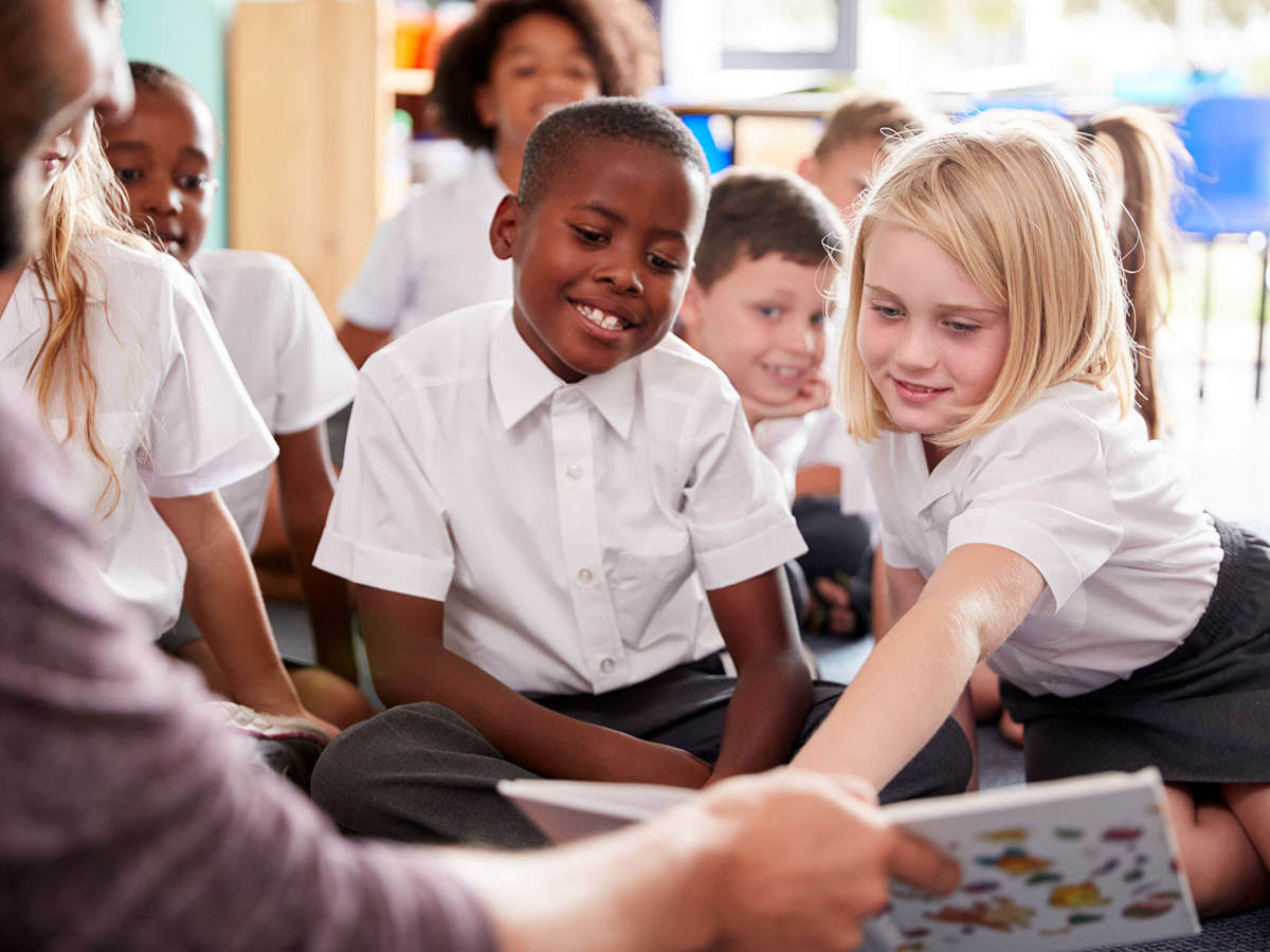 school-environment pupils and the teacher reading together