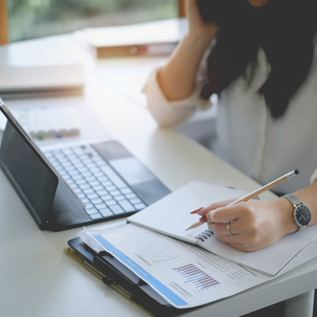 training woman writing notes off laptop