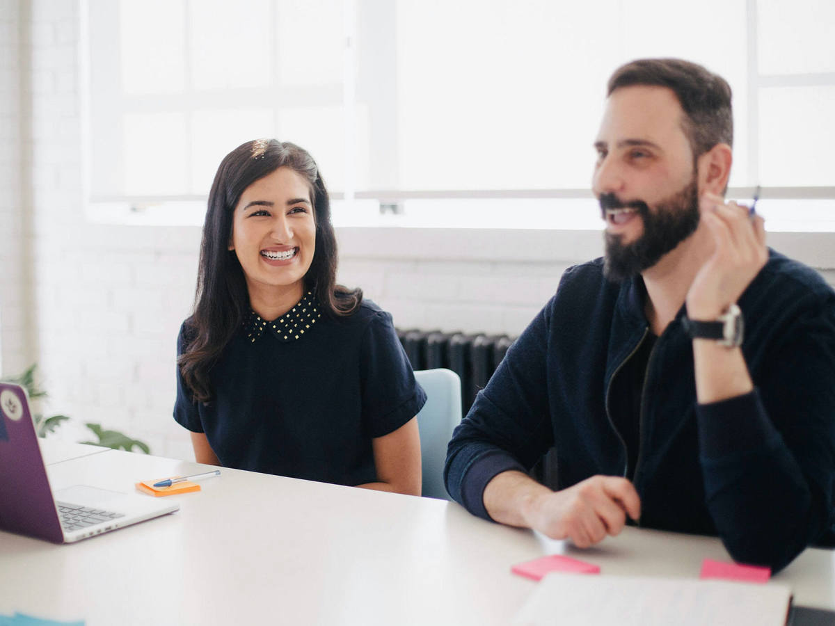Lady and man smiling during a meeting