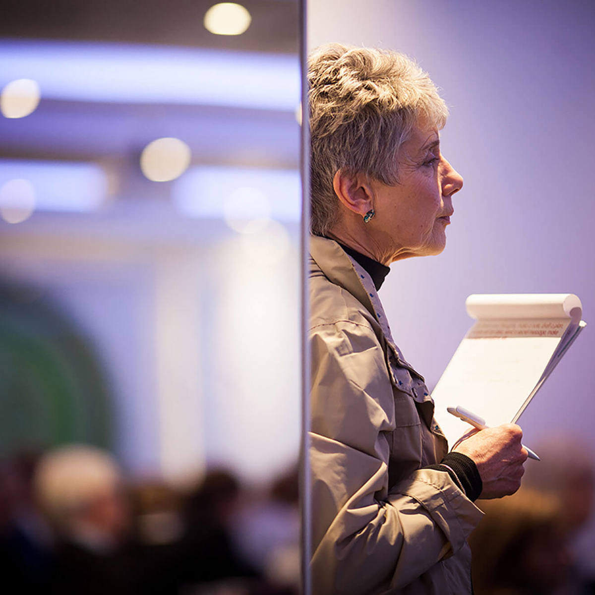 training woman standing with paper in blurred background