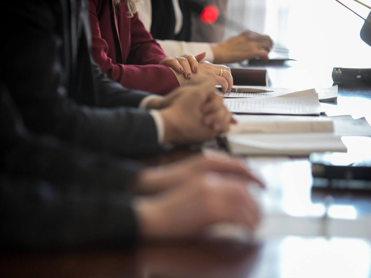 People taking notes during a meeting