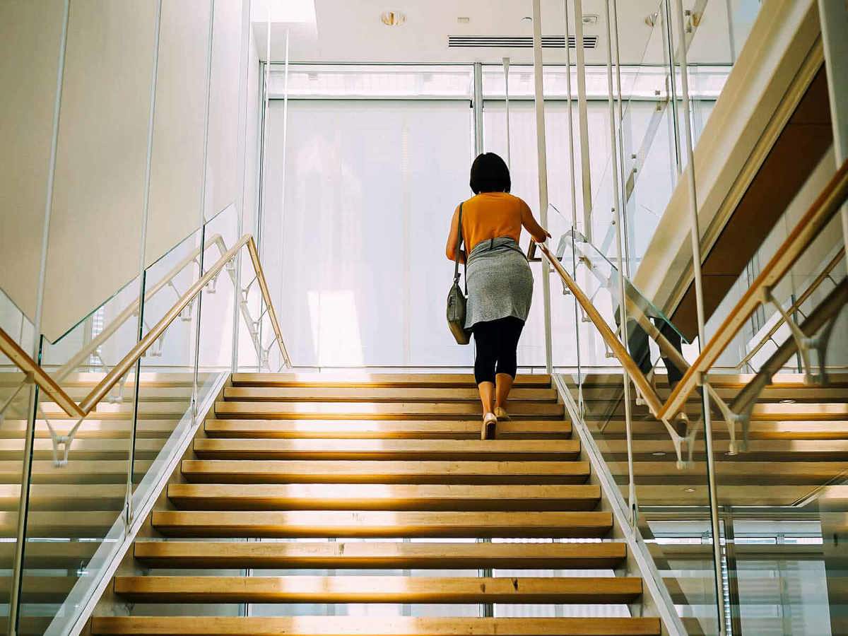 school-environment woman walking up flight of stairs