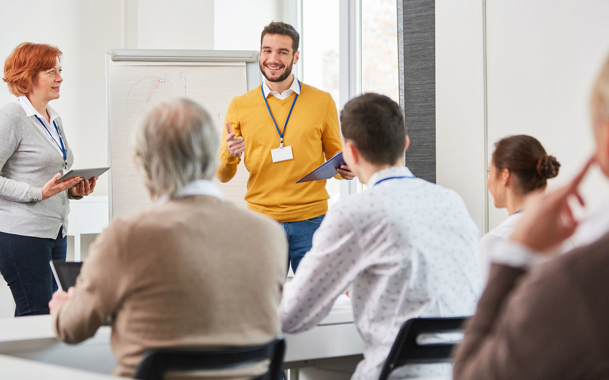 training man presenting to group of people