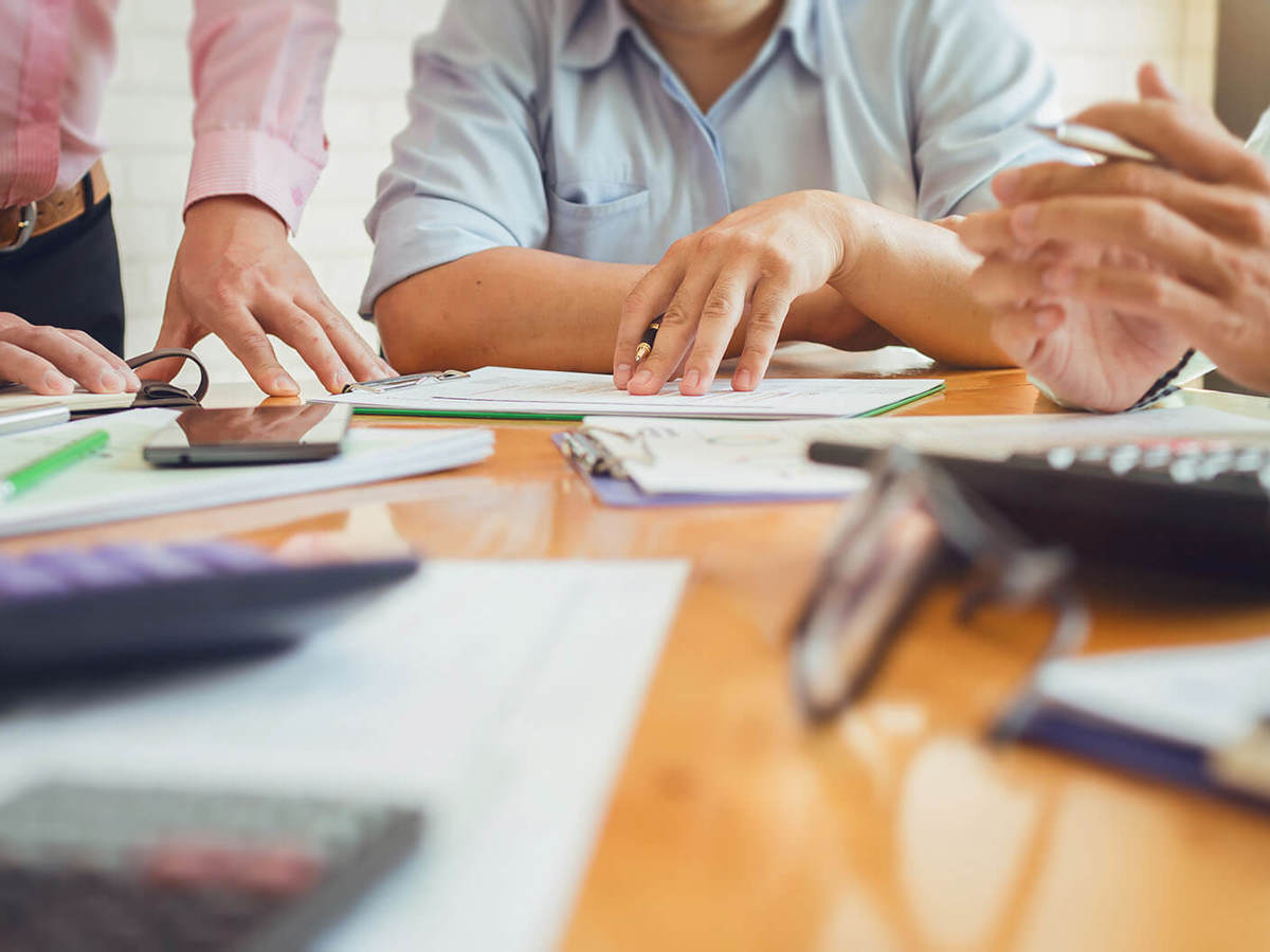 people looking over the documents from a meeting