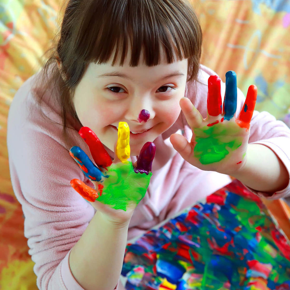 Pupils-learning pupil smiling with paint covered hands